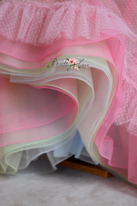 "Soft blue bridal tulle peeking through the layers of the Swish Dot Couture gown, adding a whimsical touch to the design."

