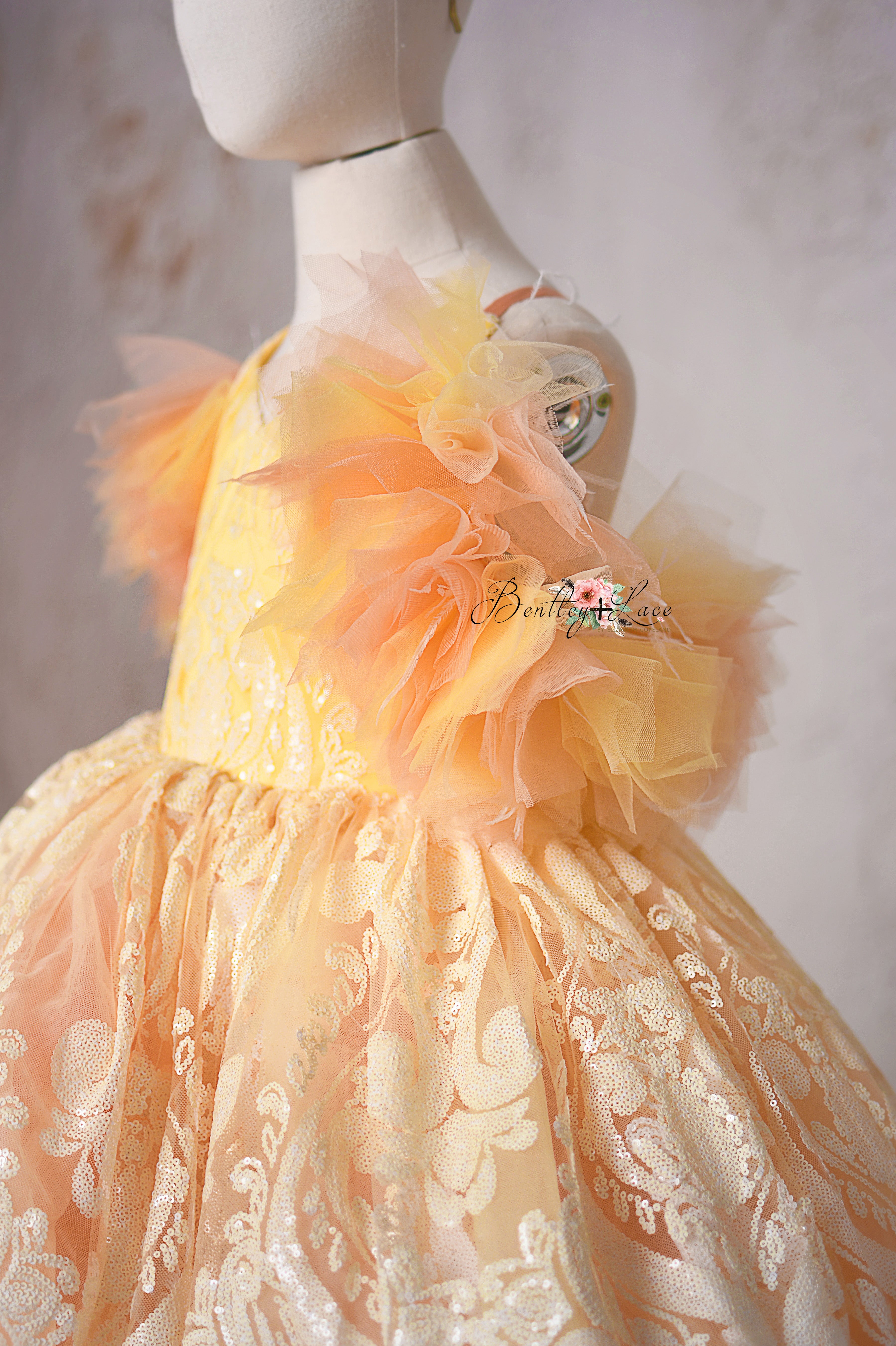 "Sugar Kisses" gown featuring a soft ombré coral and yellow color palette.
