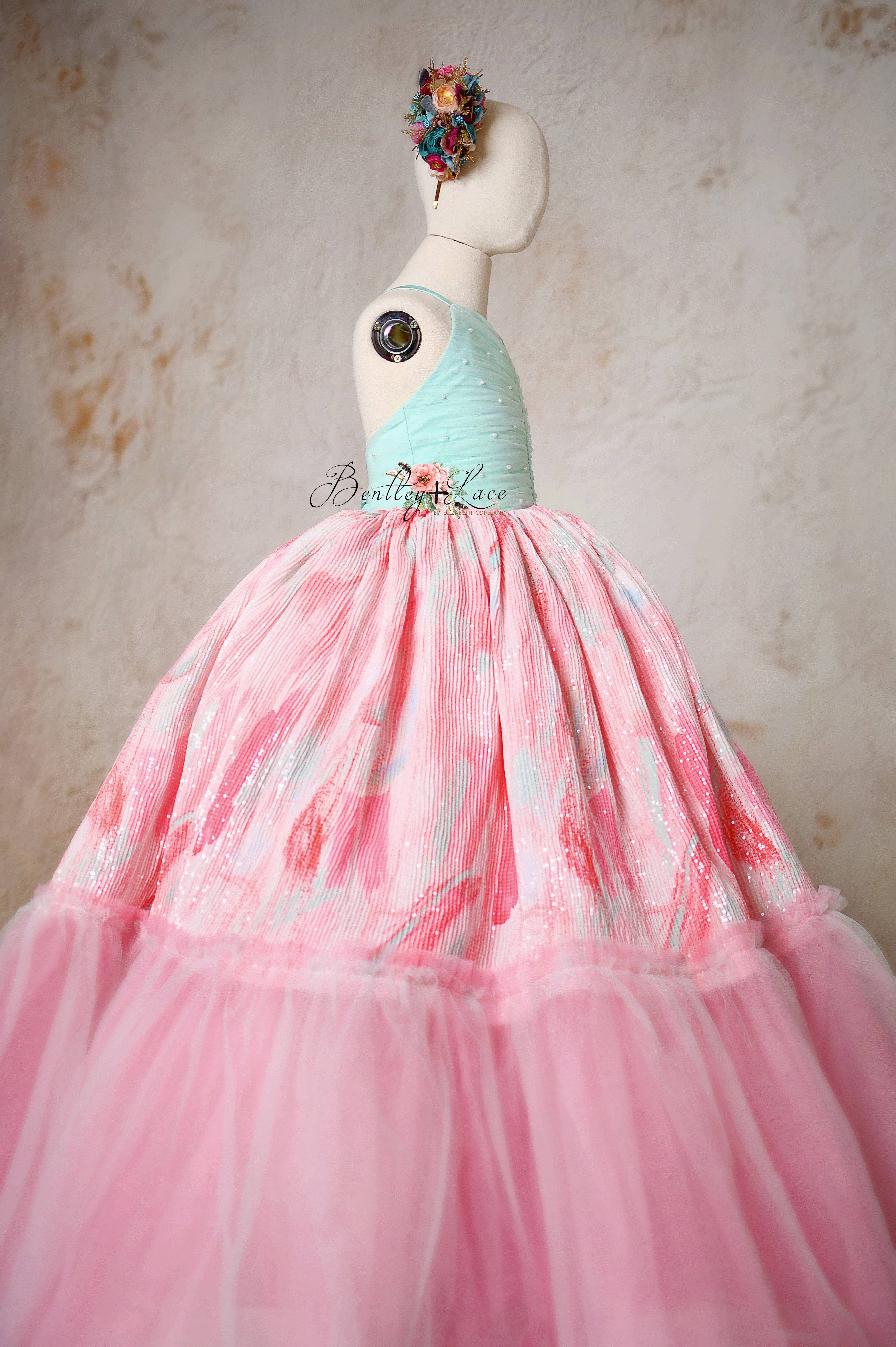 "Cotton Candy Dream gown displayed on a mannequin, showcasing its pastel hues and elegant design."
