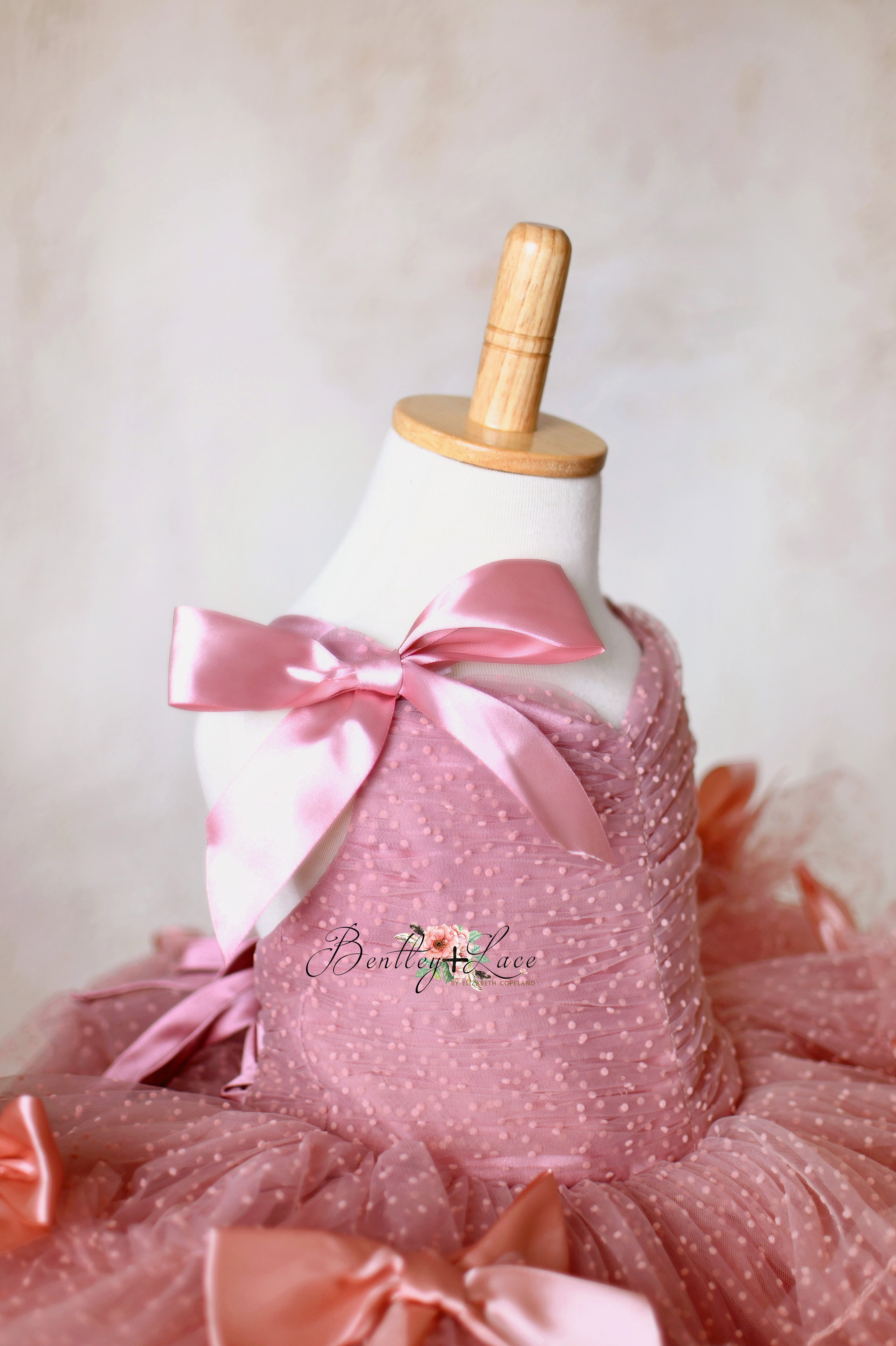 Fairytale-inspired baby dress with delicate tulle layers and charming satin ribbon details.
