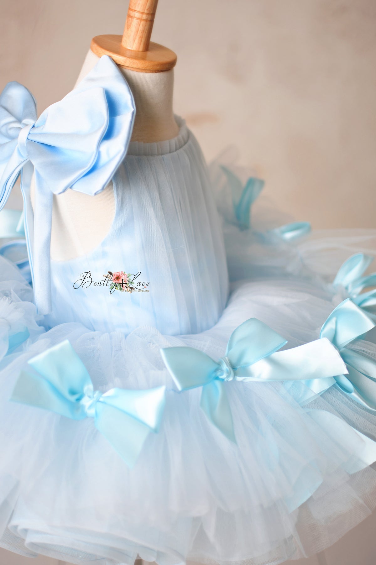 Luxurious bridal tulle dress with a flattering fit and satin bow accents.

