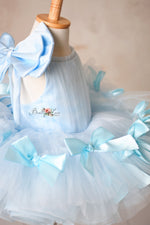 Luxurious bridal tulle dress with a flattering fit and satin bow accents.

