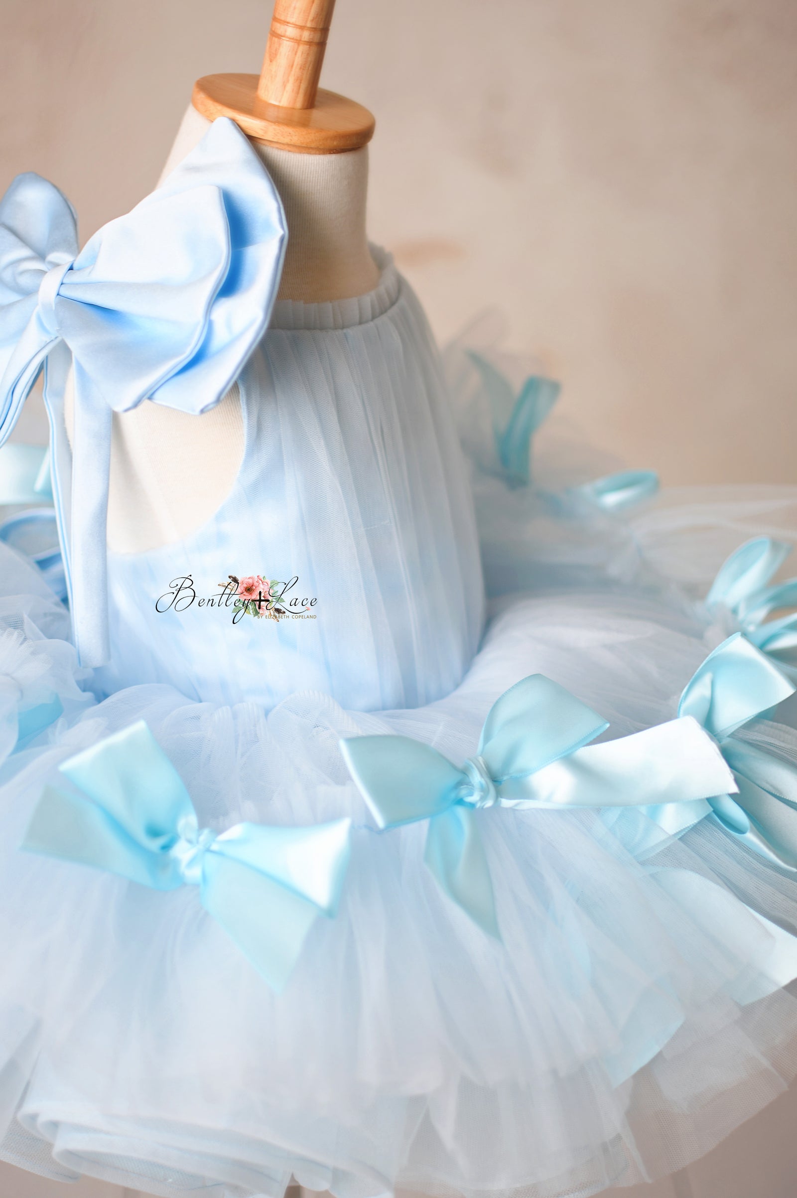 Luxurious bridal tulle dress with a flattering fit and satin bow accents.

