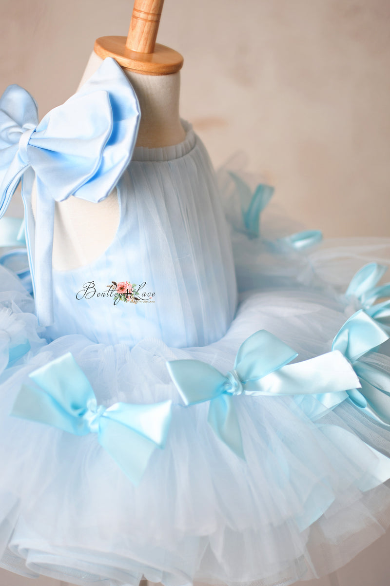 Luxurious bridal tulle dress with a flattering fit and satin bow accents.

