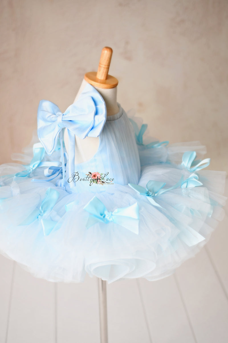 Handmade satin bows embellish this ethereal soft tulle dress.

