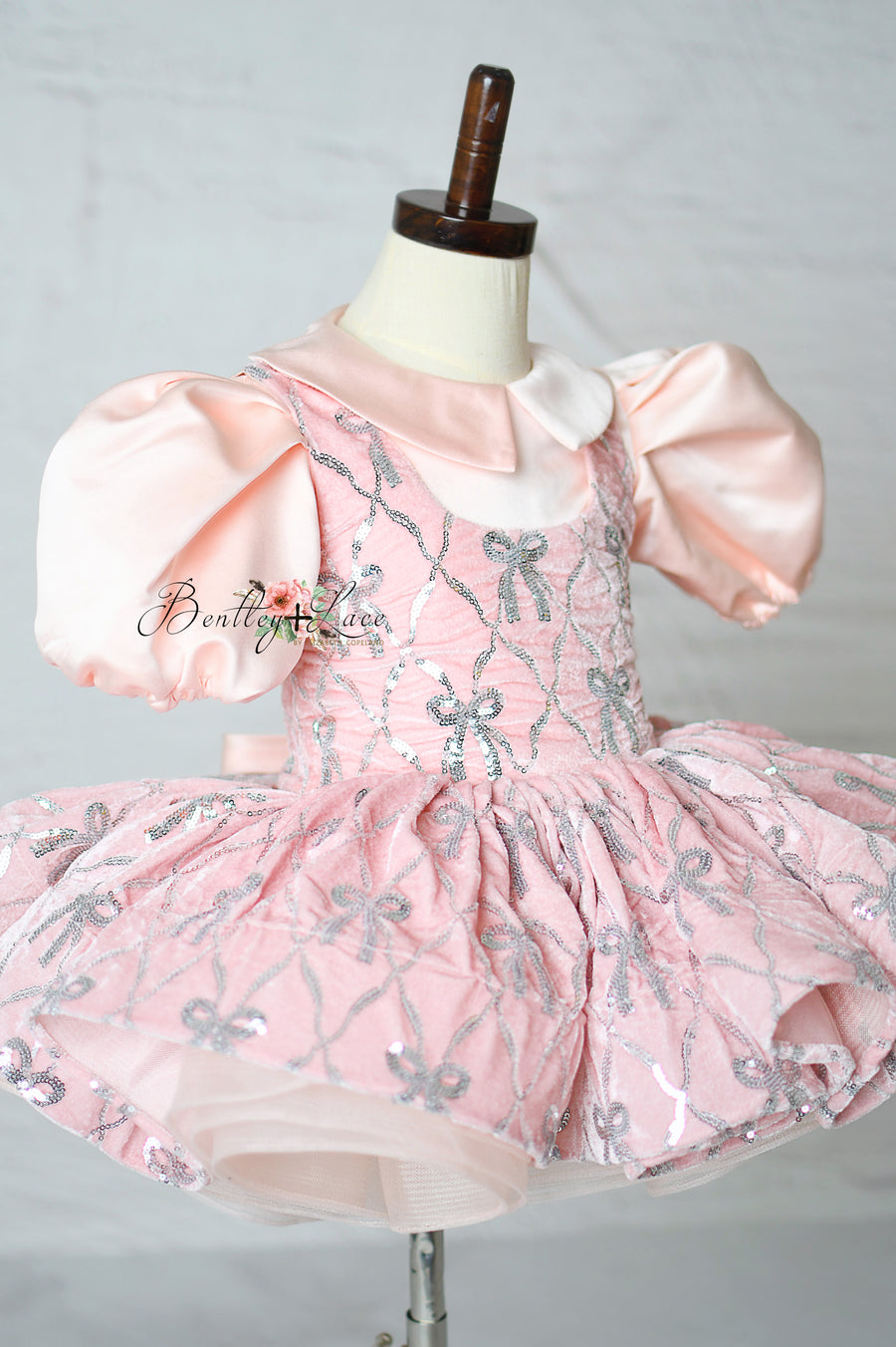 "Girls pink pageant dress with detailed bow embroidery"

