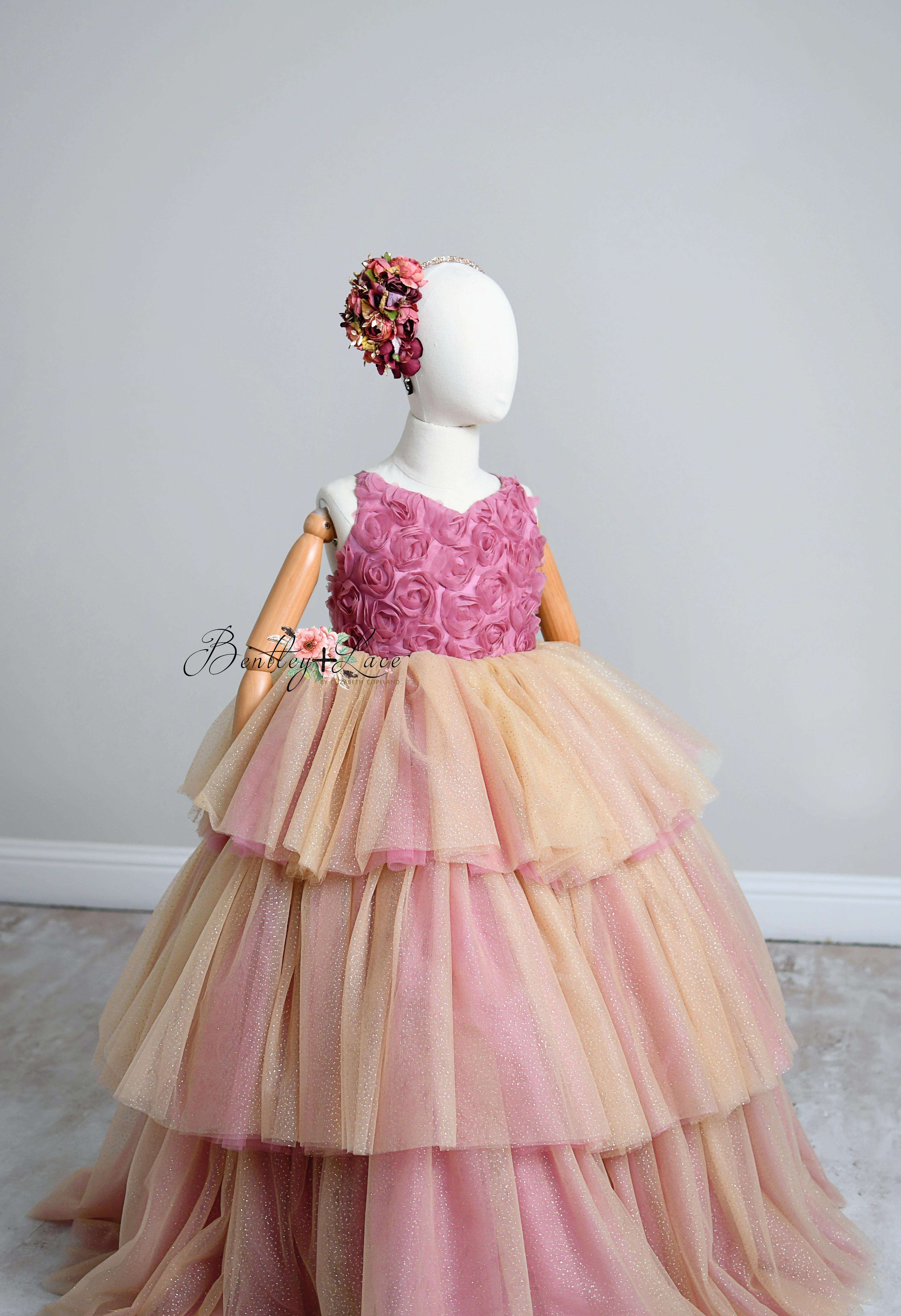 Layers of tiered tulle in shades of gold and blush, creating a dreamy skirt.
