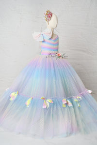 Close-up of the Colorful Bliss Gown’s rainbow swiss dot fabric, capturing its whimsical texture and vibrant, joyful color palette.

