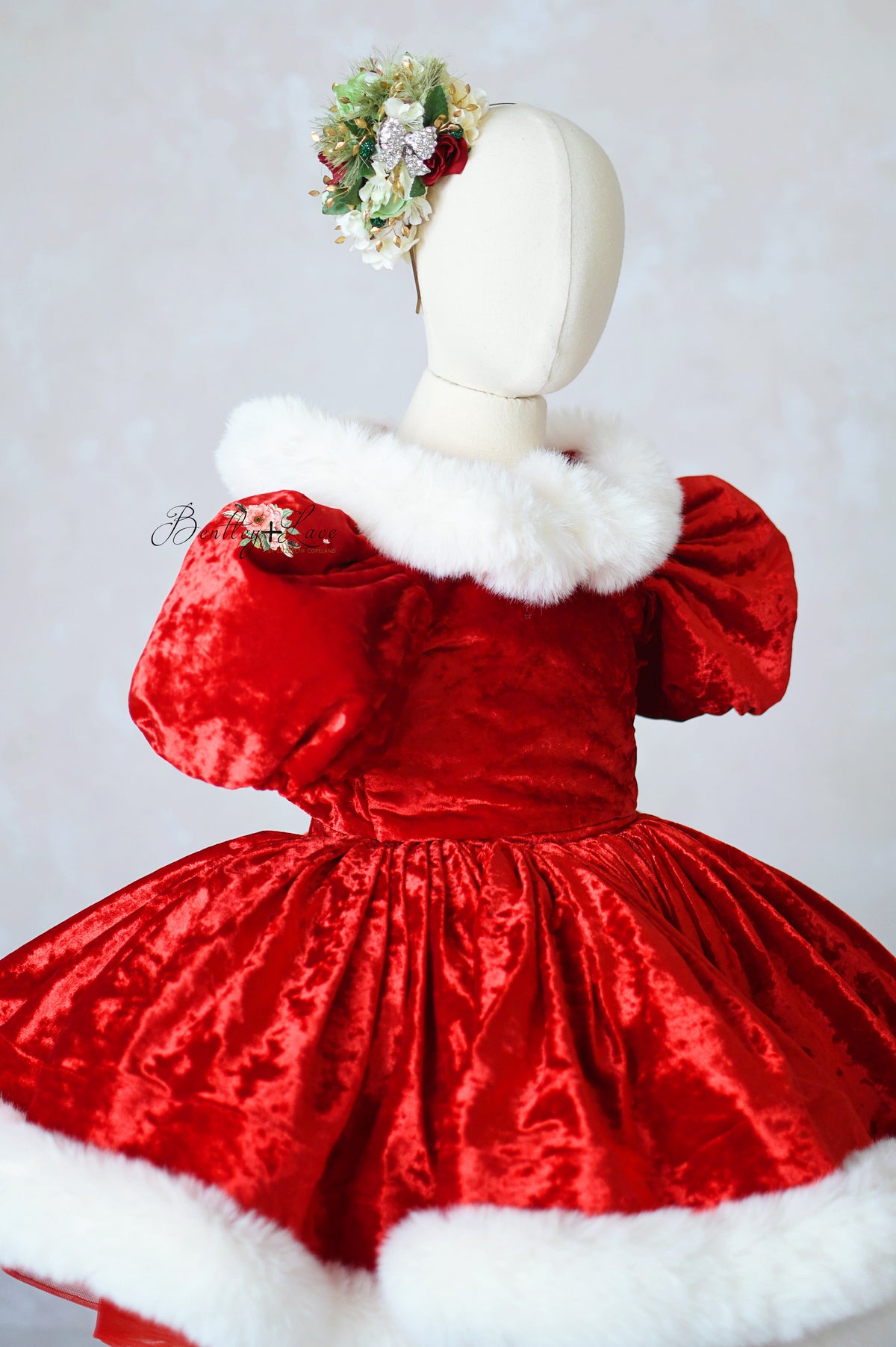 Red velvet gown with oversized detachable bow for holiday photography

