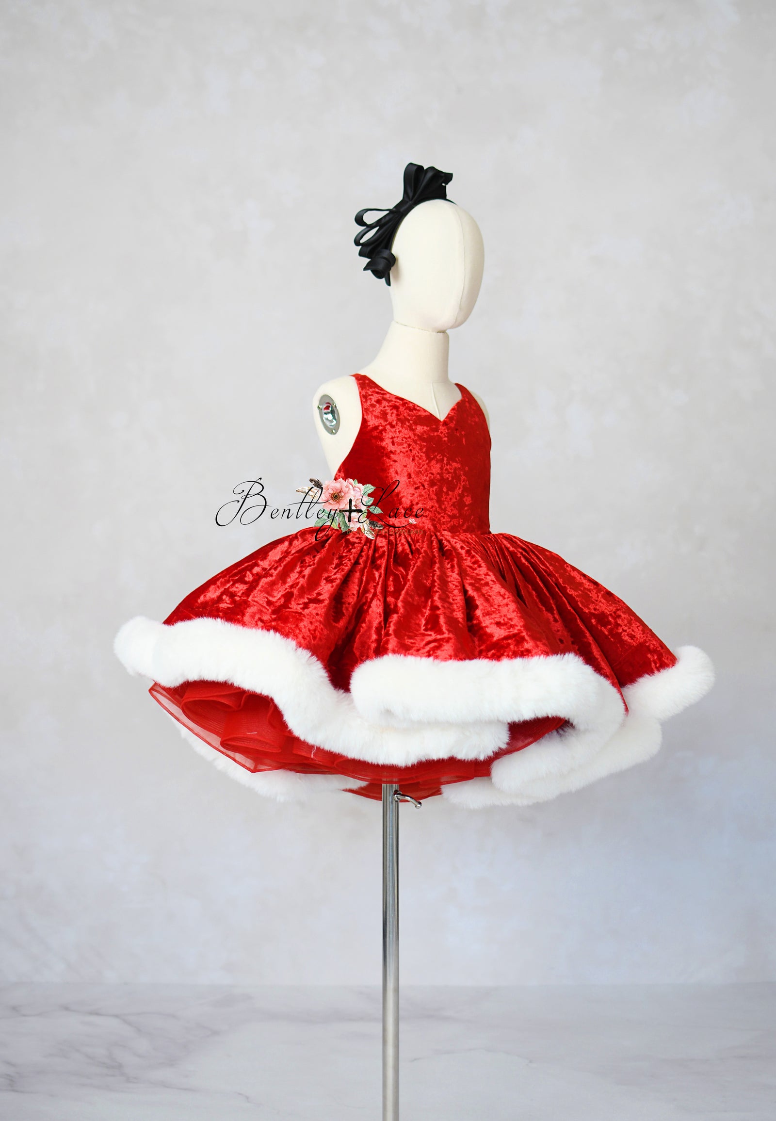 Styled holiday shoot featuring luxury Mrs. Claus gown for girls

