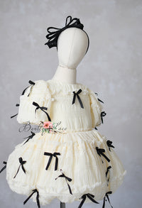 Ivory smocked dress with black bows and puff sleeves for girls, ages 6–8 — Bentley and Lace couture gown.

