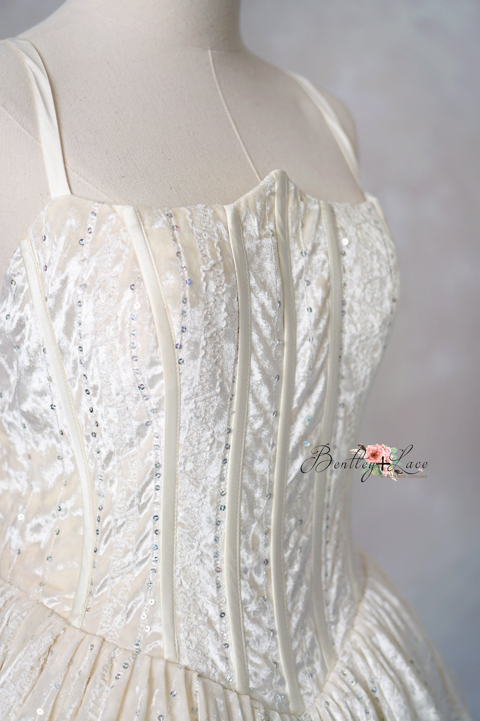 Shows the gown’s side structure and flow while giving a flattering view of the model.

