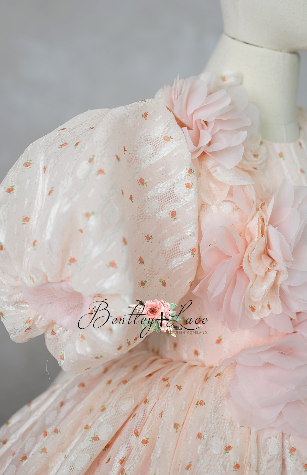 "Luxury children's gown styled on mannequin with floral headband"

