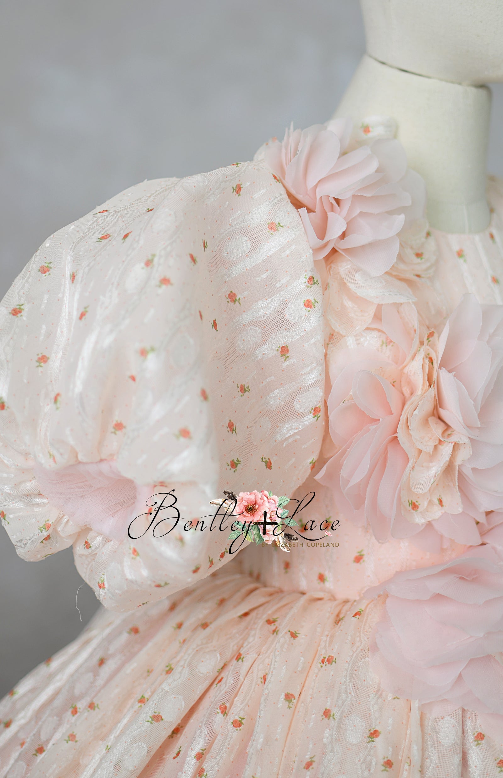"Luxury children's gown styled on mannequin with floral headband"

