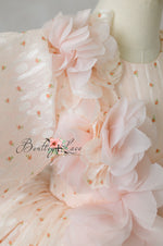 "Side view of elegant children’s formal dress with cascading rosettes"

