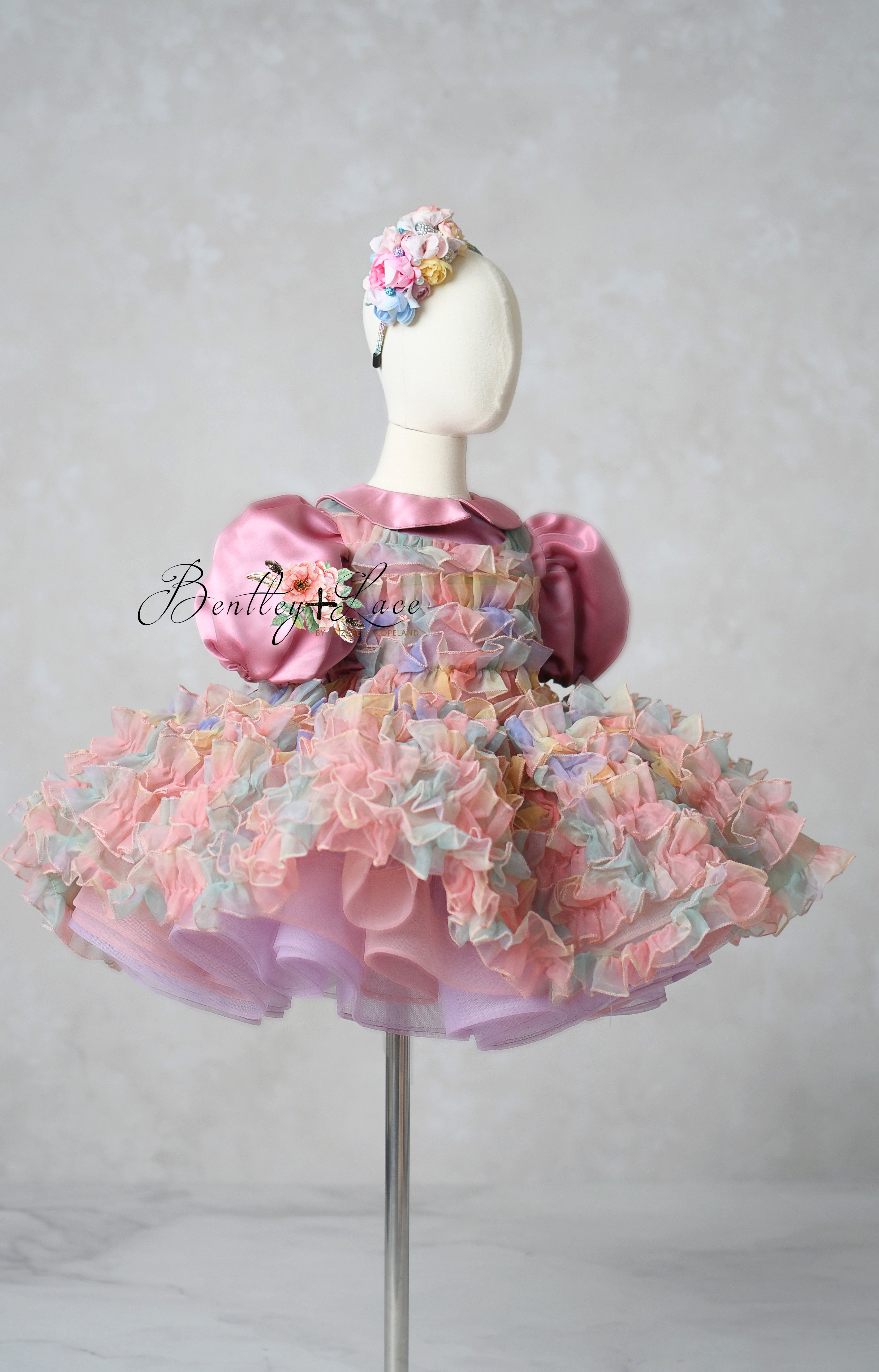 Front view of pastel ruffle dress with puff sleeves and bow – perfect for photography

