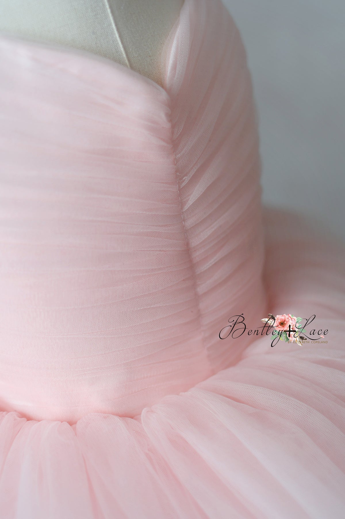 Close-up of pink fabric with a brand logo in the corner