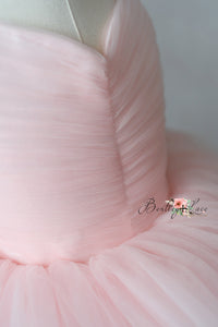 Close-up of pink fabric with a brand logo in the corner