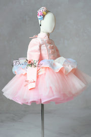 Pink dress with floral headband on a mannequin against a gray background