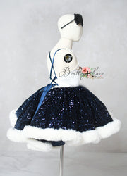 Mannequin wearing a navy blue sequin skirt with white trim on a gray background