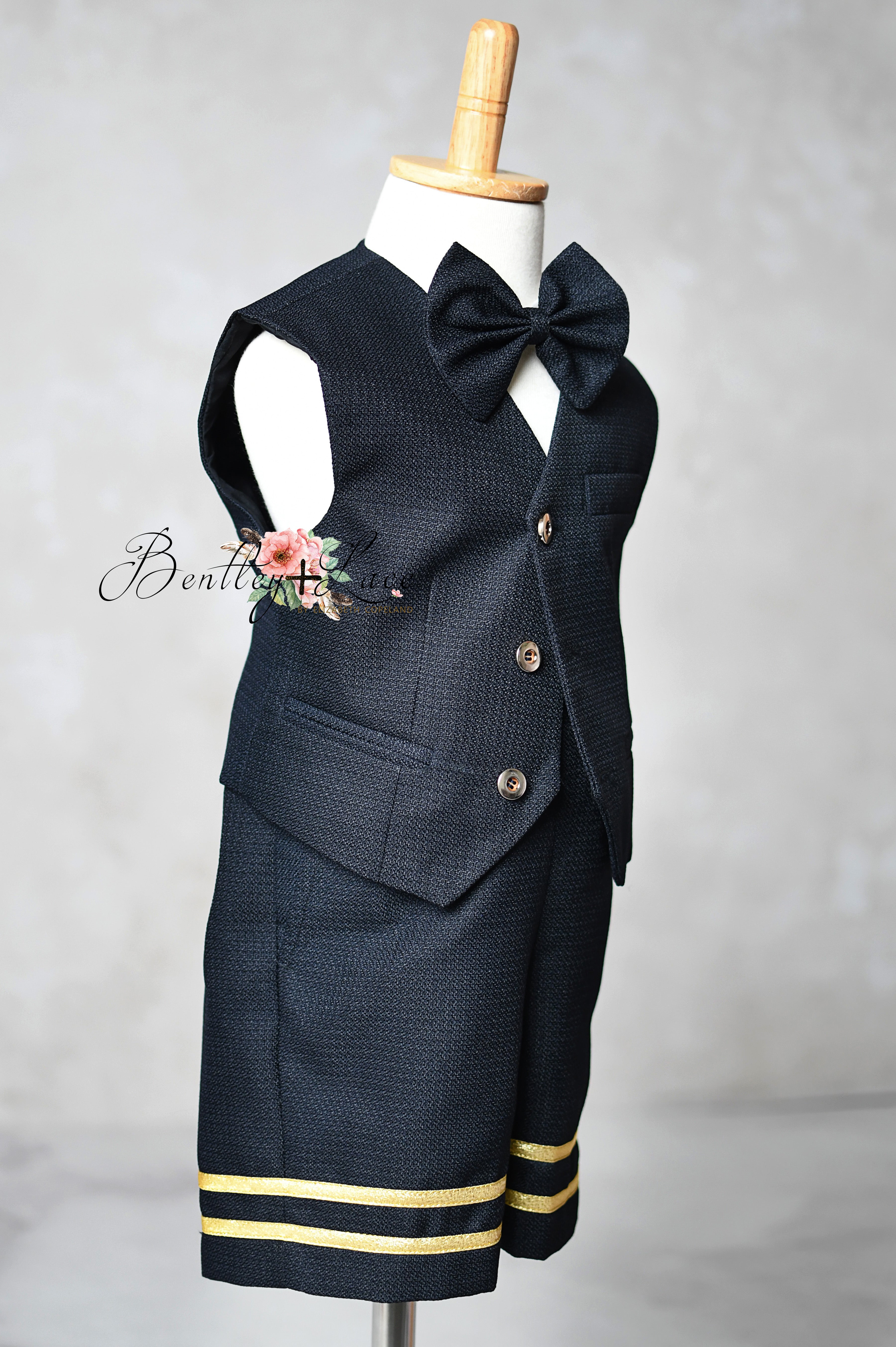 Navy blue suit with bow tie on a mannequin against a gray background