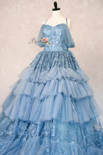 Blue ball gown on a mannequin against a plain background