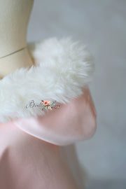 Close-up of a white fluffy object on a blurred background with 'Boutique Love' branding.