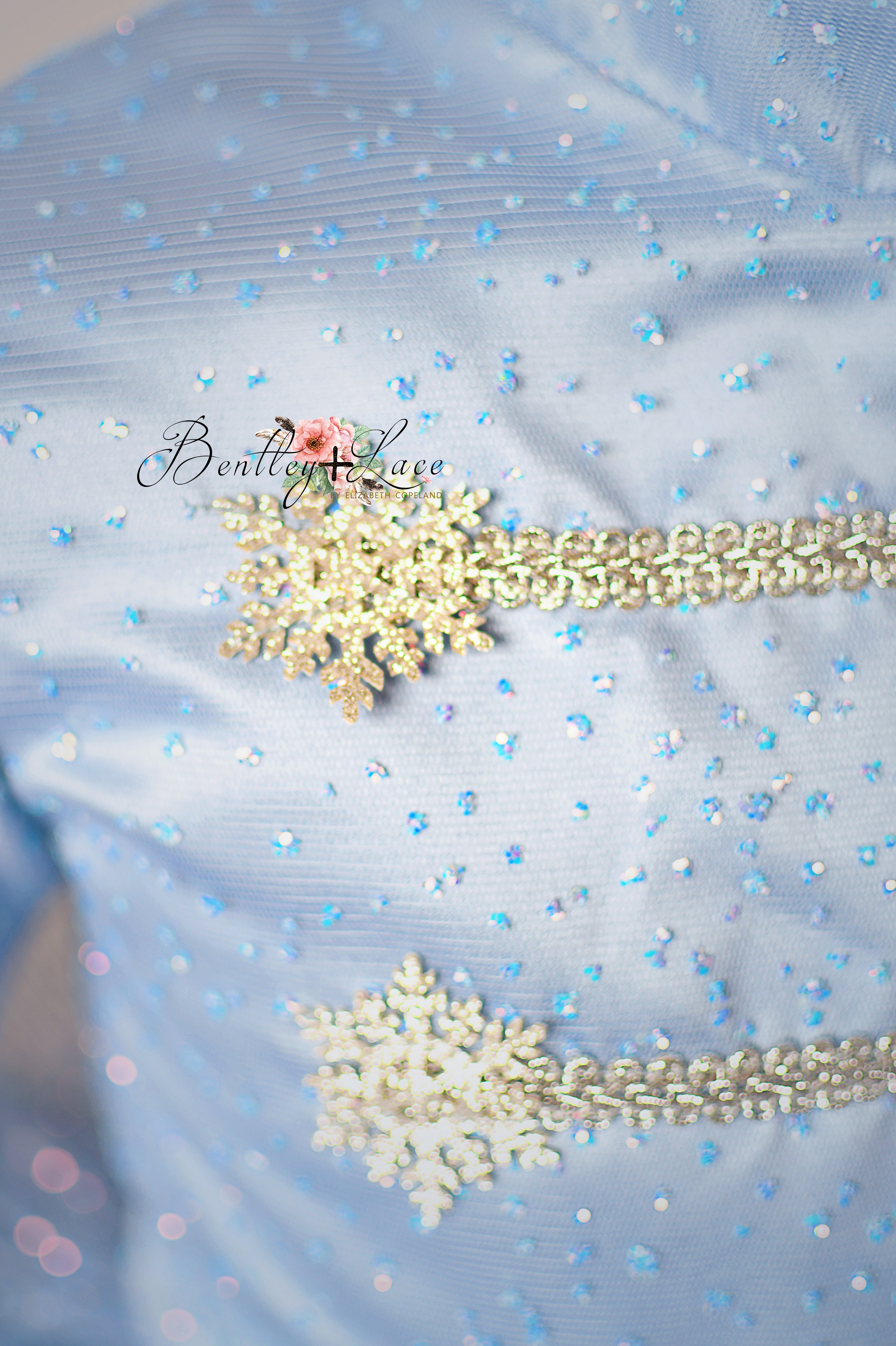 Decorative brooches on a light blue fabric background
