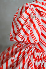 red and white striped Candy Cane Lane Dress for a Christmas photo session.