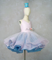 Mannequin wearing a two-tone pink and blue dress with a headband on a plain background.
