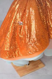 Children’s couture Halloween dress in sparkling orange sequins with optional feather details