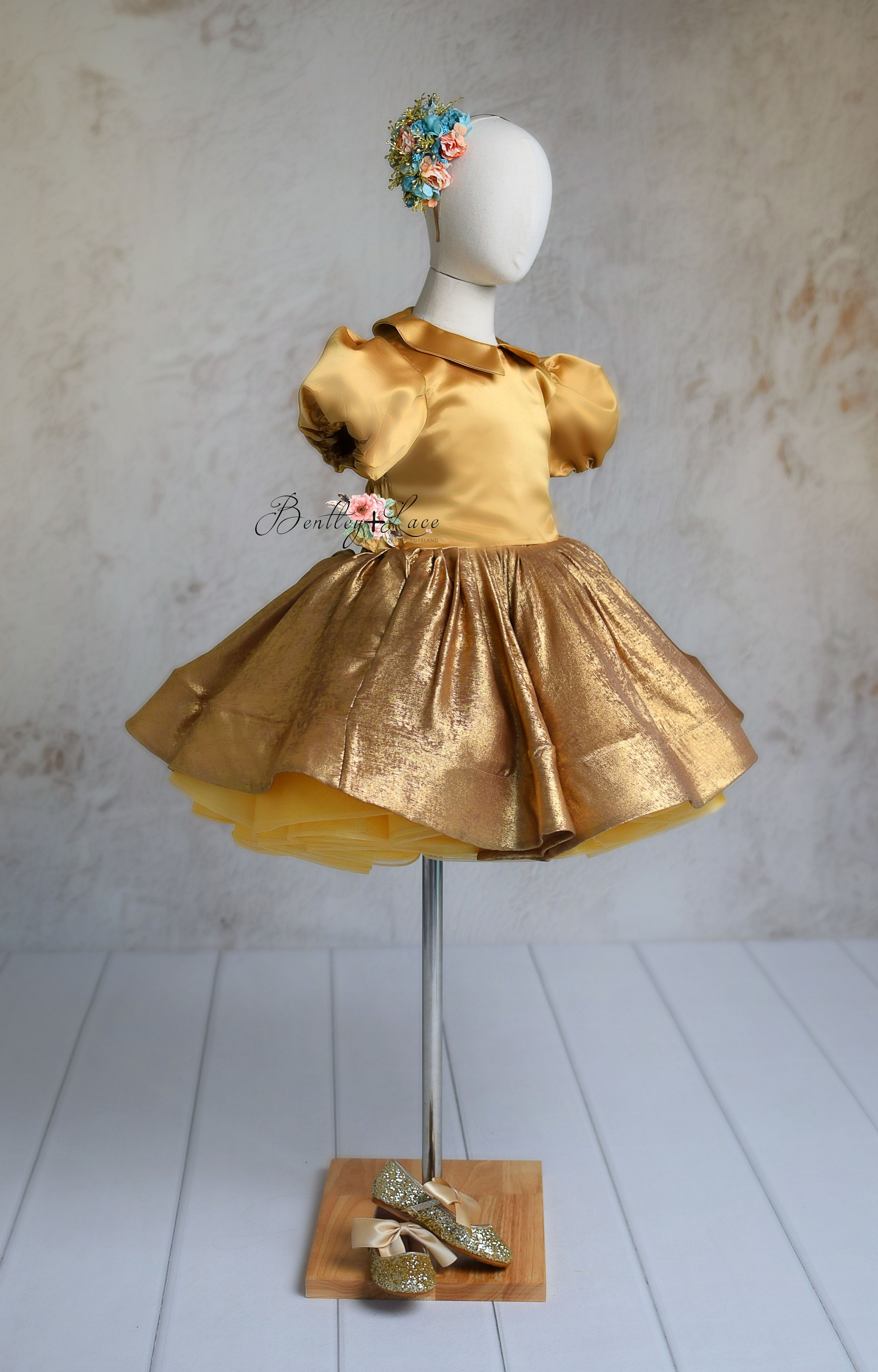 Golden Belle dress in a side view highlighting its flowy skirt."