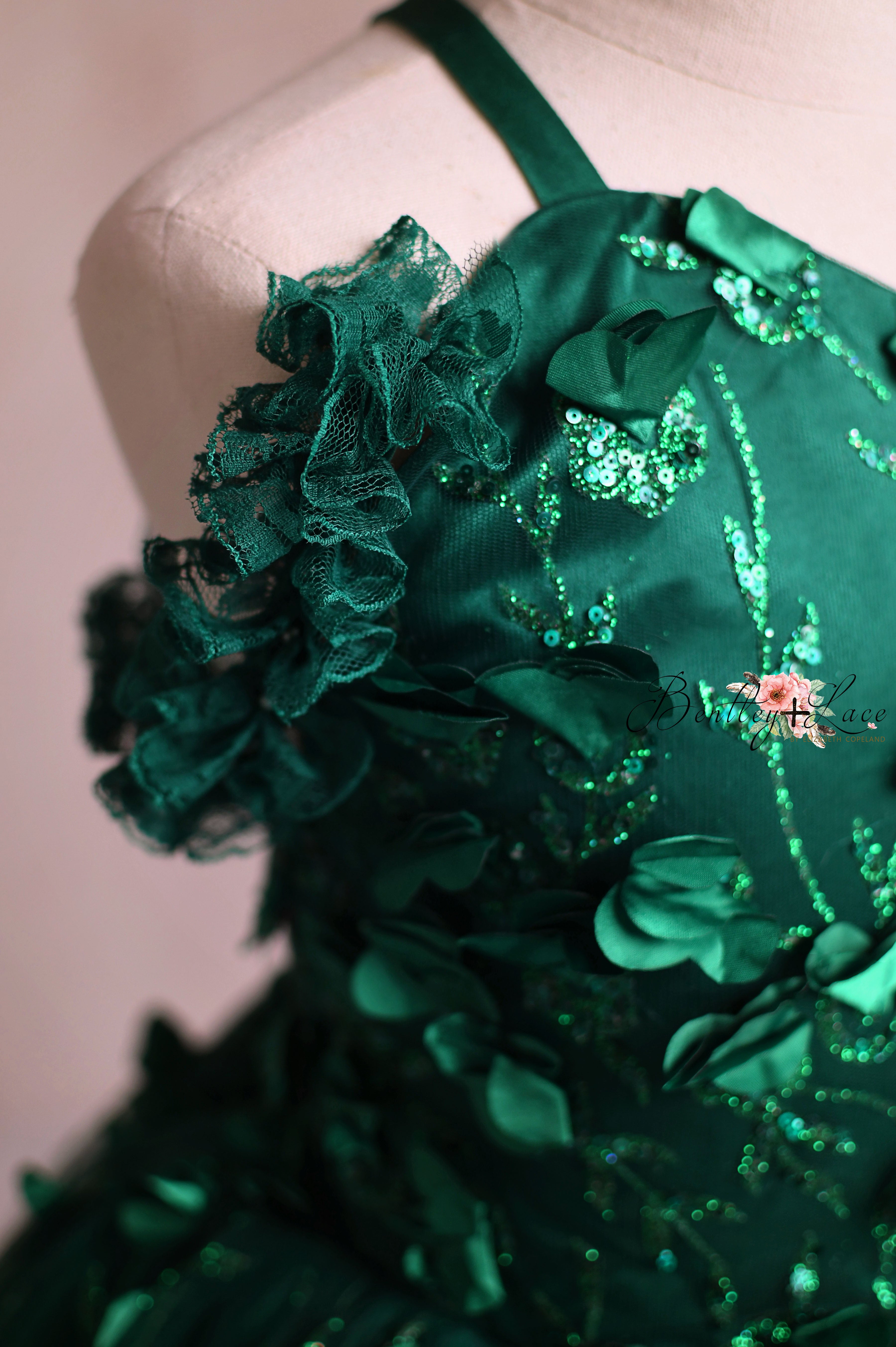 Beautifully crafted green formal dress with a full skirt and flower accents