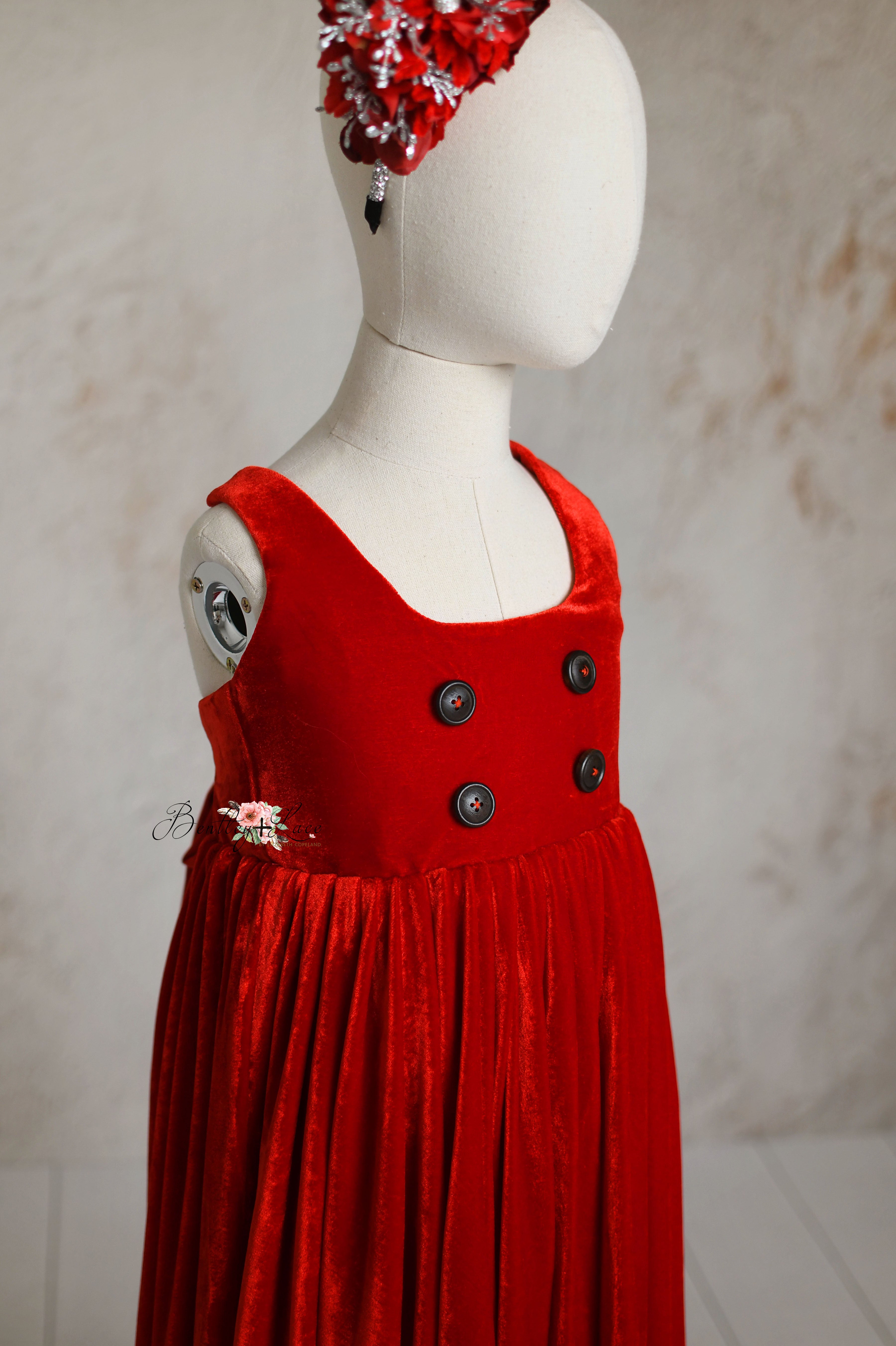 Front view of the Santa's Helper red velvet dress showcasing its classic design and soft fabric.