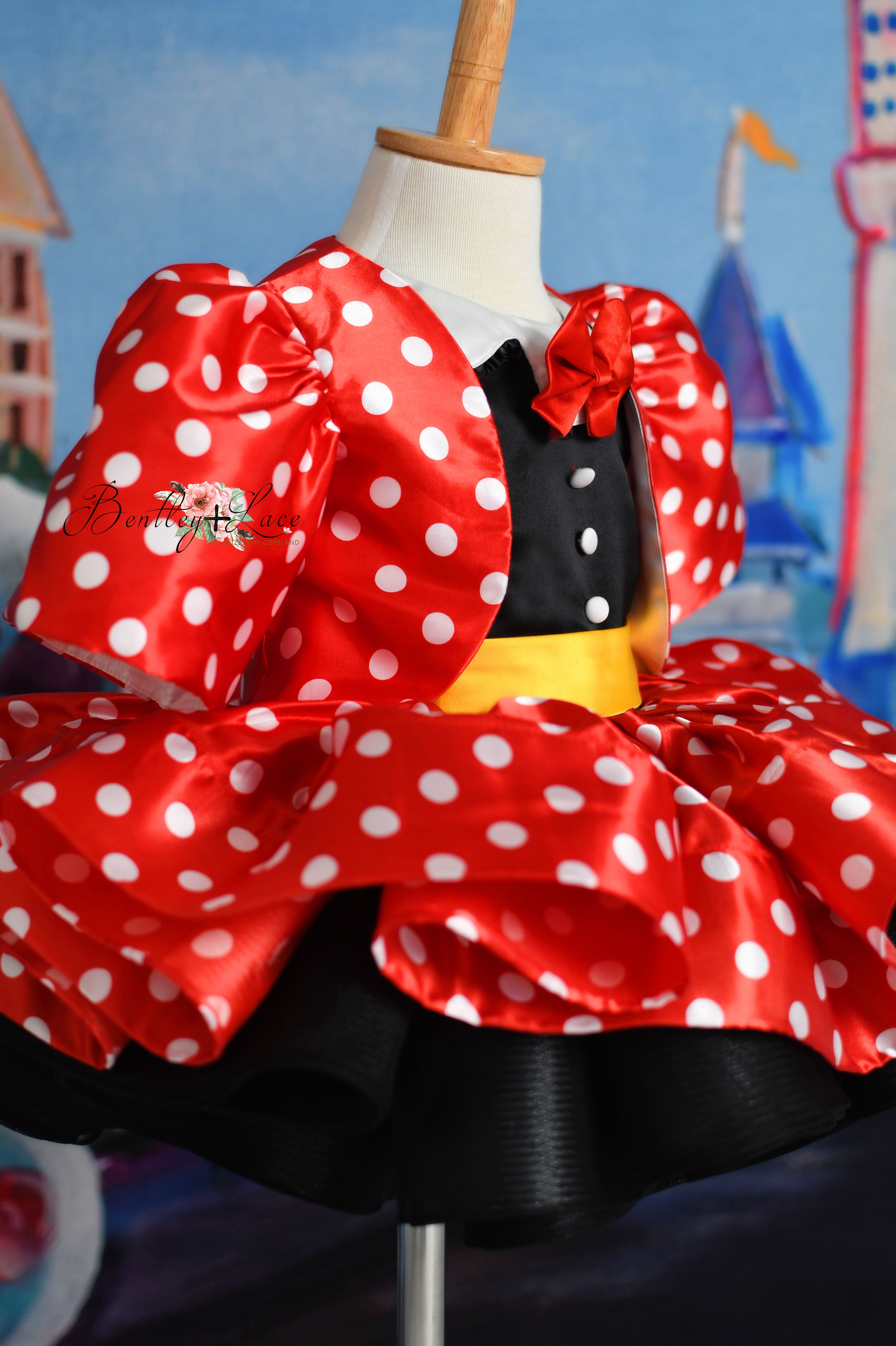 Adorable petal-length gown for toddler girls in Minnie Mouse-inspired polka dots.