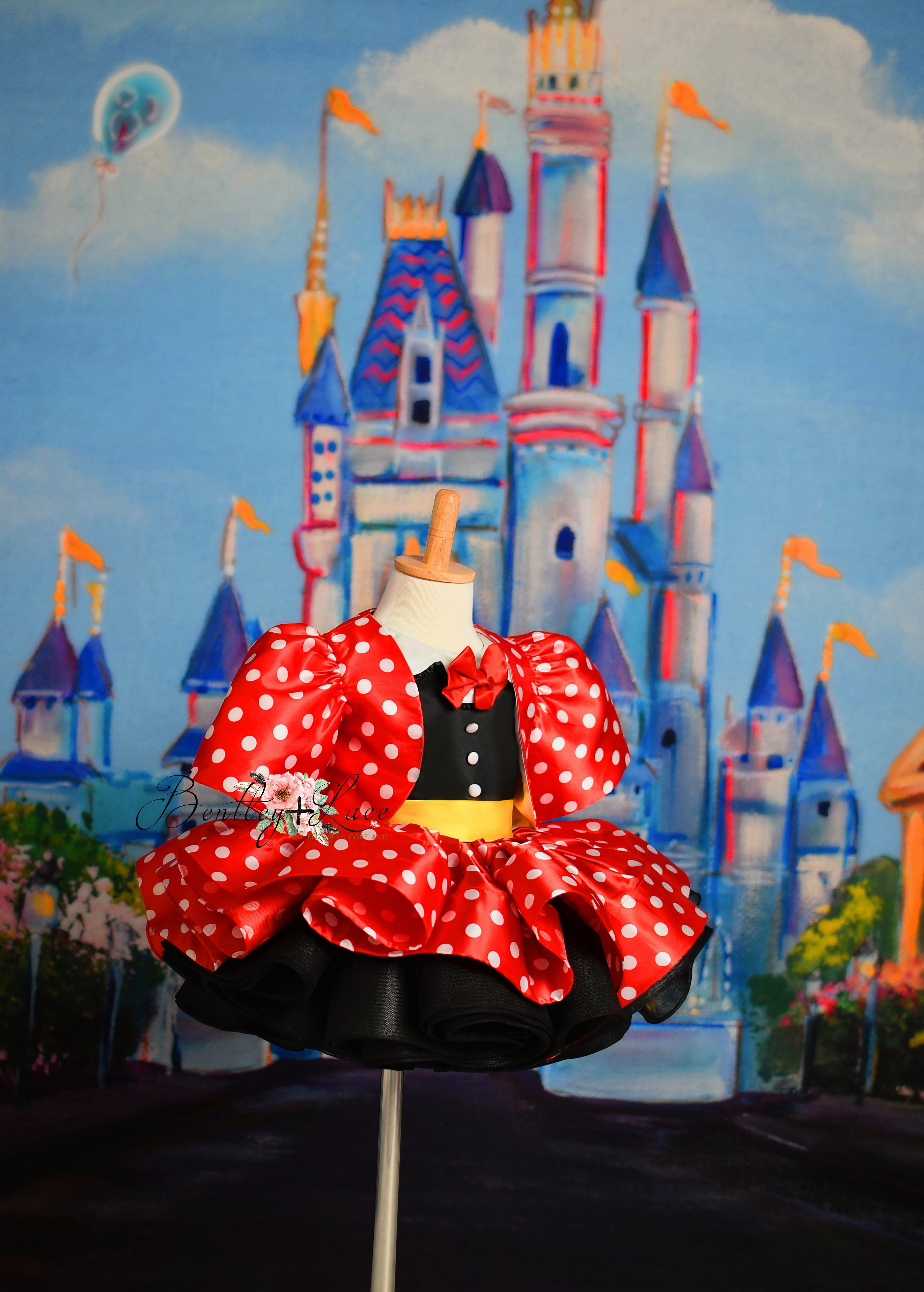 Close-up of the "Miss Mouse" dress featuring classic polka dots and a detachable jacket for added charm.