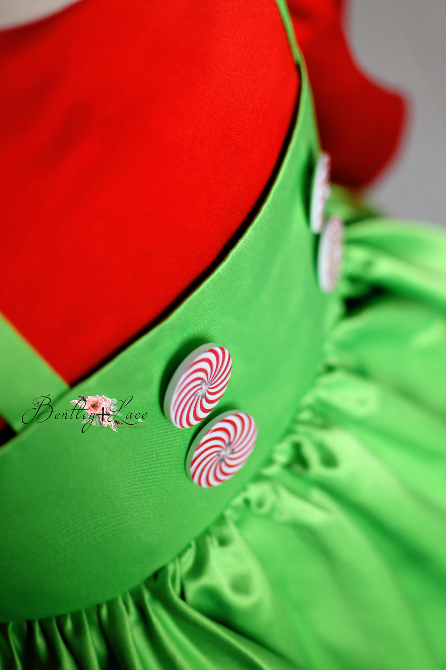 Holiday dress from the Mischief-Maker Set featuring a removable bow and detailed apron with candy and heart designs.

