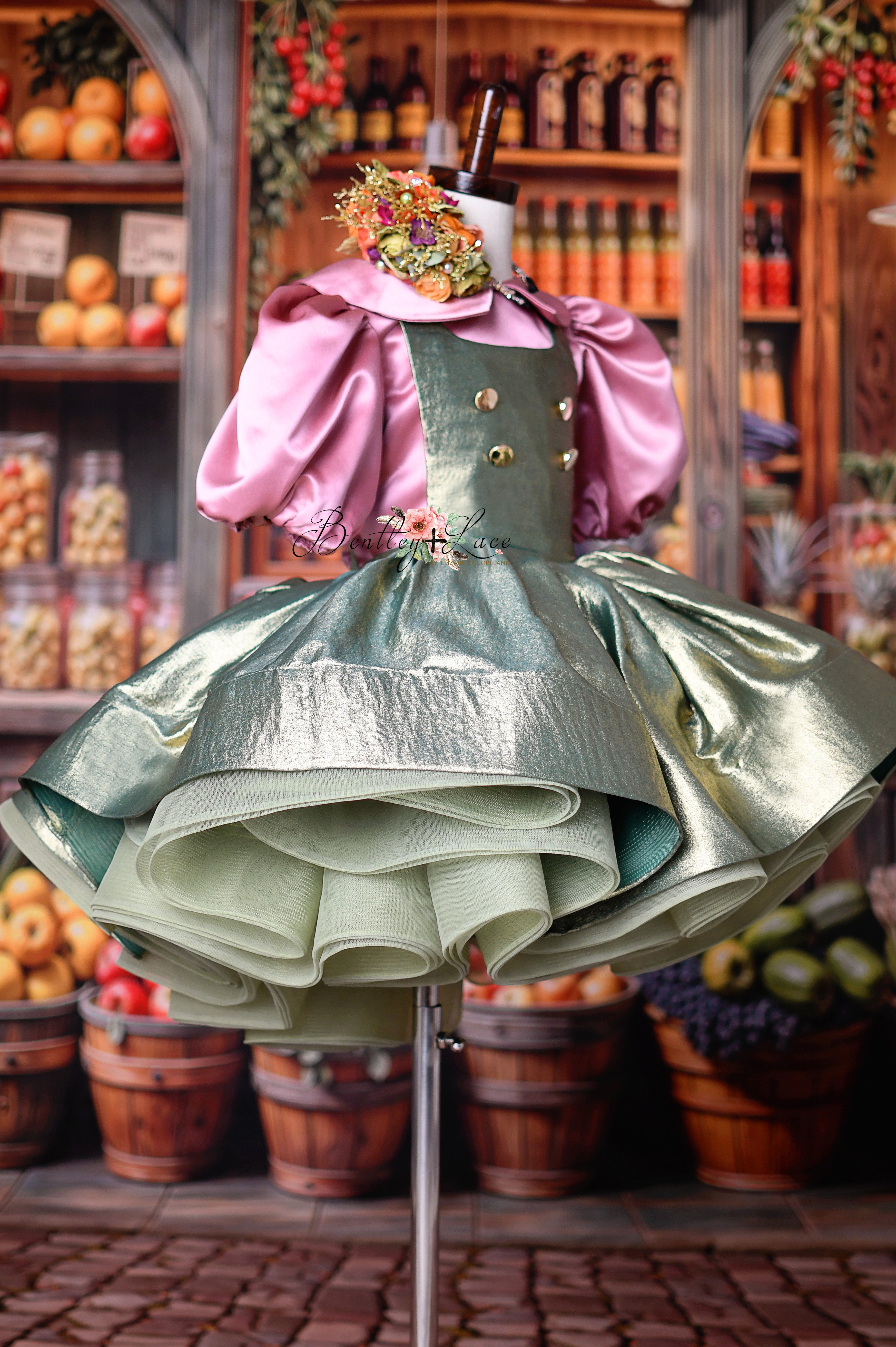 Golden Belle Dress displayed with petal-apron detailing in sage and blush tones.