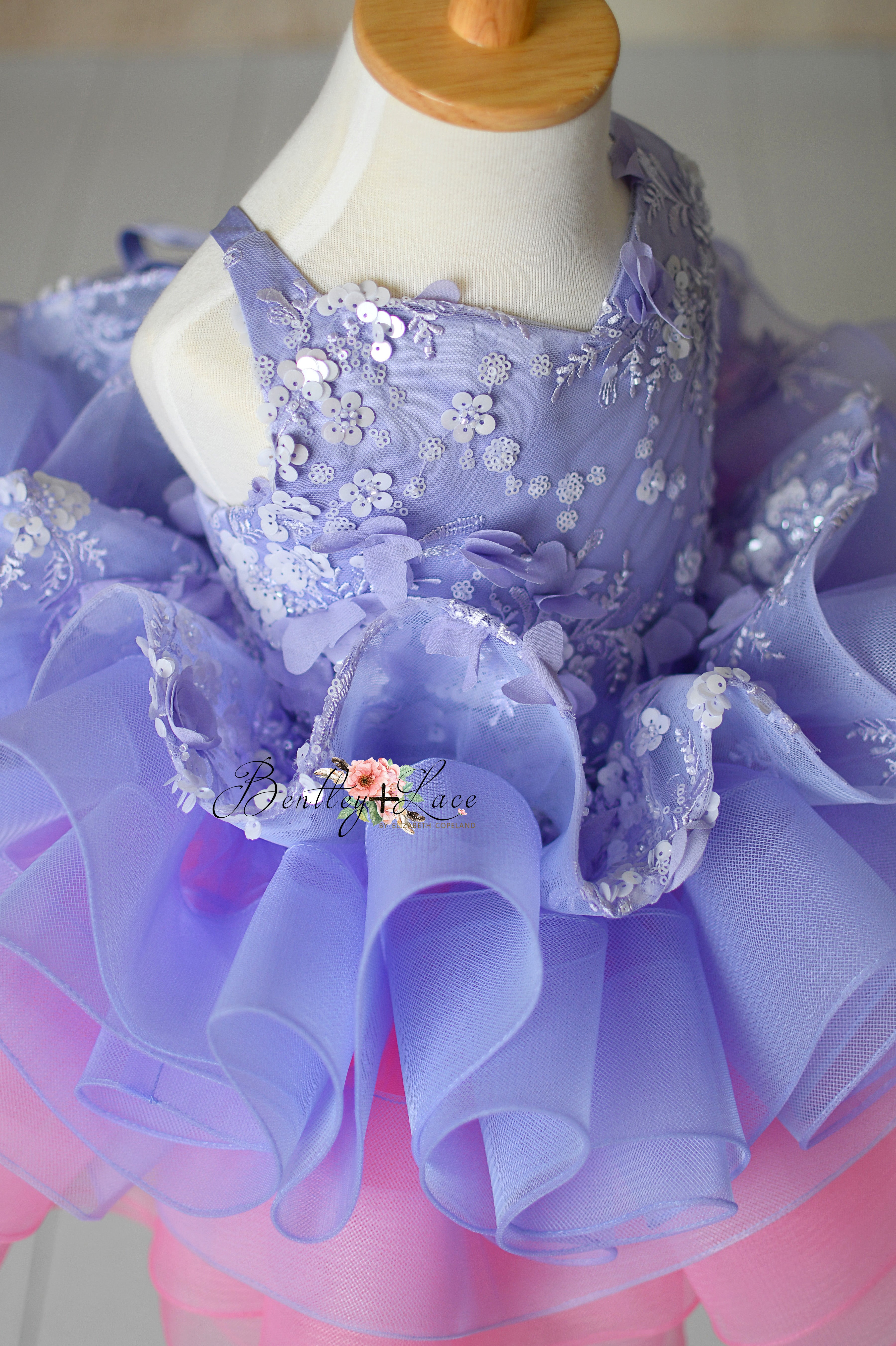 Full shot of the Lilac Enchantment dress with its dreamy layered tulle skirt, creating a flowing, whimsical effect.
