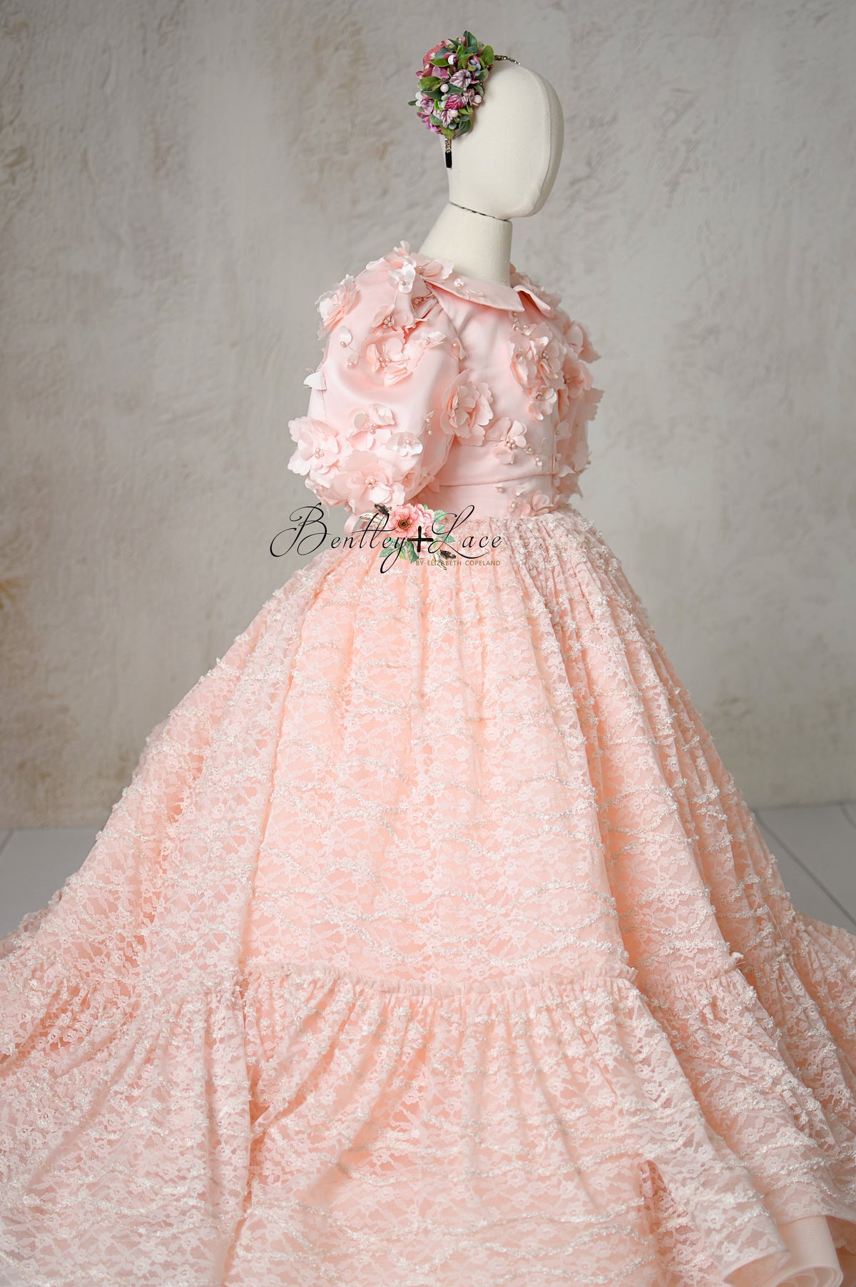 Close-up of Rosette Reverie’s satin bodice with floral details.
