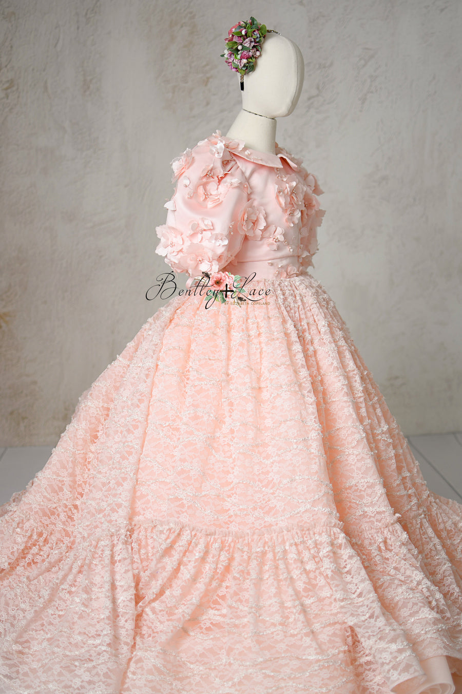 Close-up of Rosette Reverie’s satin bodice with floral details.

