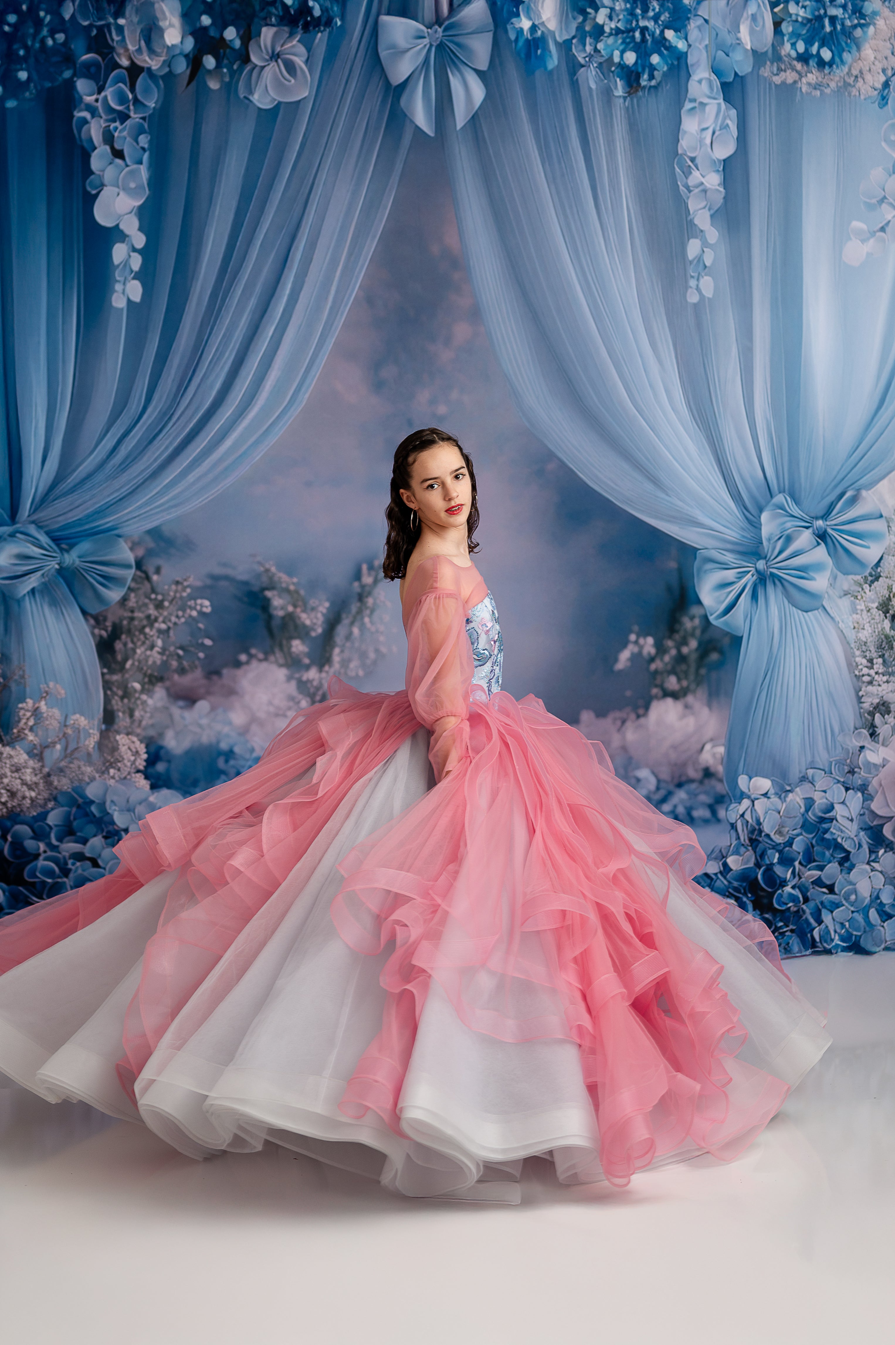 Blush & Blossoms" floor-length gown showcasing its elegant cascading tulle skirting, creating a royal, princess-like look.