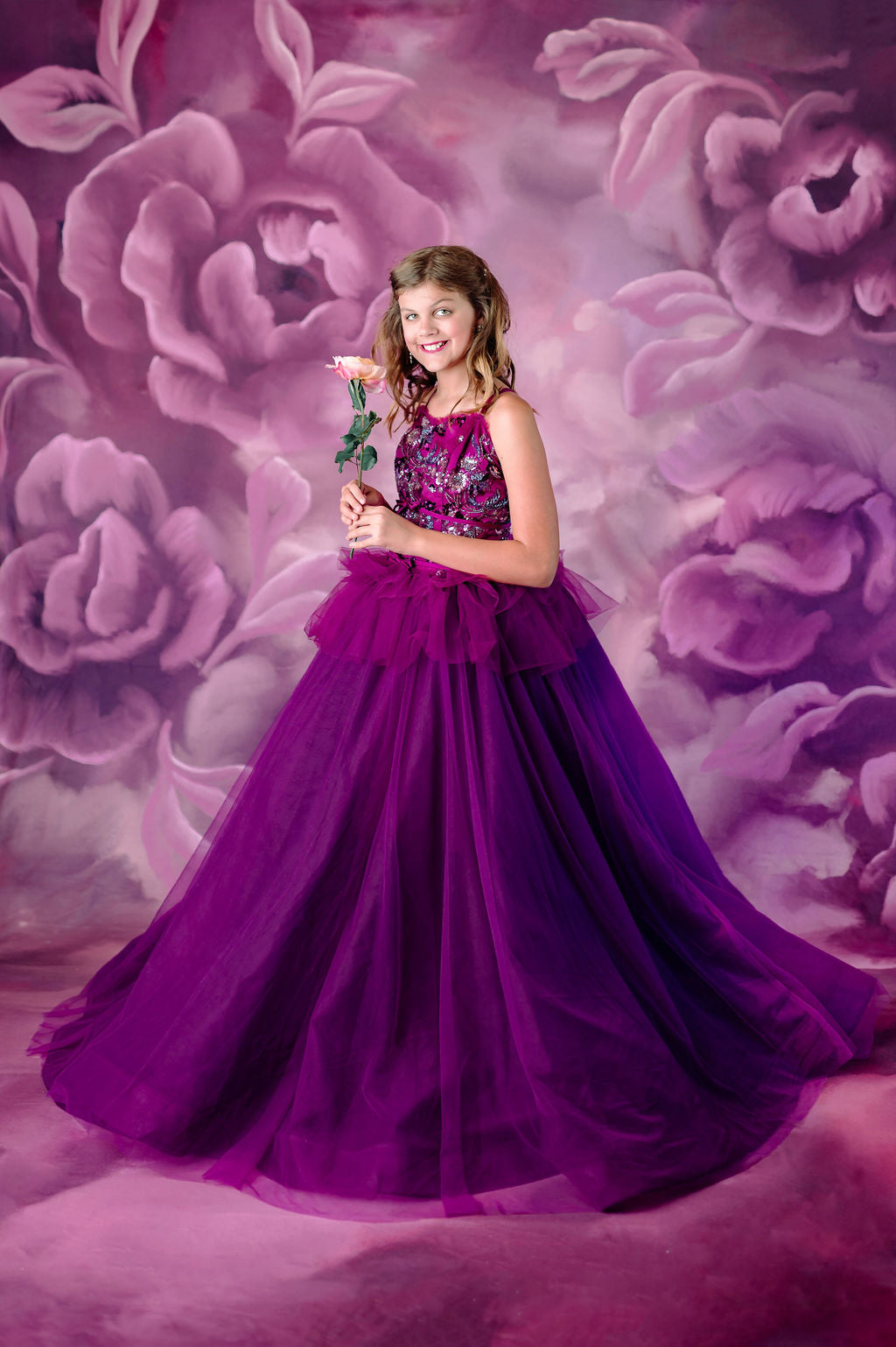 Flowing purple tulle gown perfect for children's formal photoshoots.
