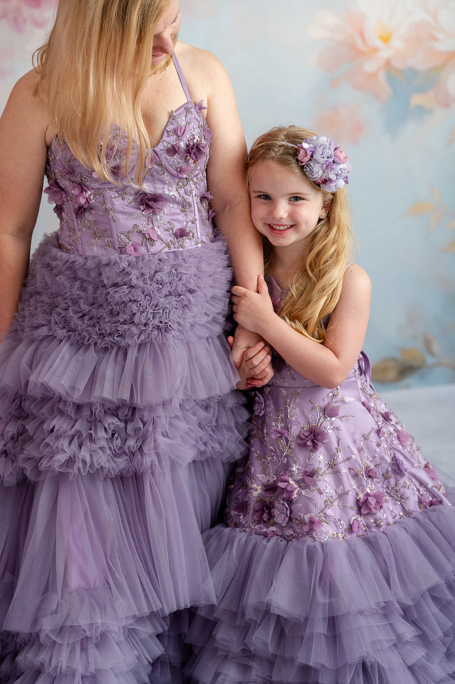 Dreamy mommy and me photo with flowing lavender gowns and hand-sewn floral appliqués.

