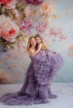 Close-up of mom and daughter embracing in Violet Grace gowns with floral appliqués.

