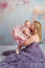 Elegant mommy and me styled shoot with lavender tulle gowns and garden-inspired setting.

