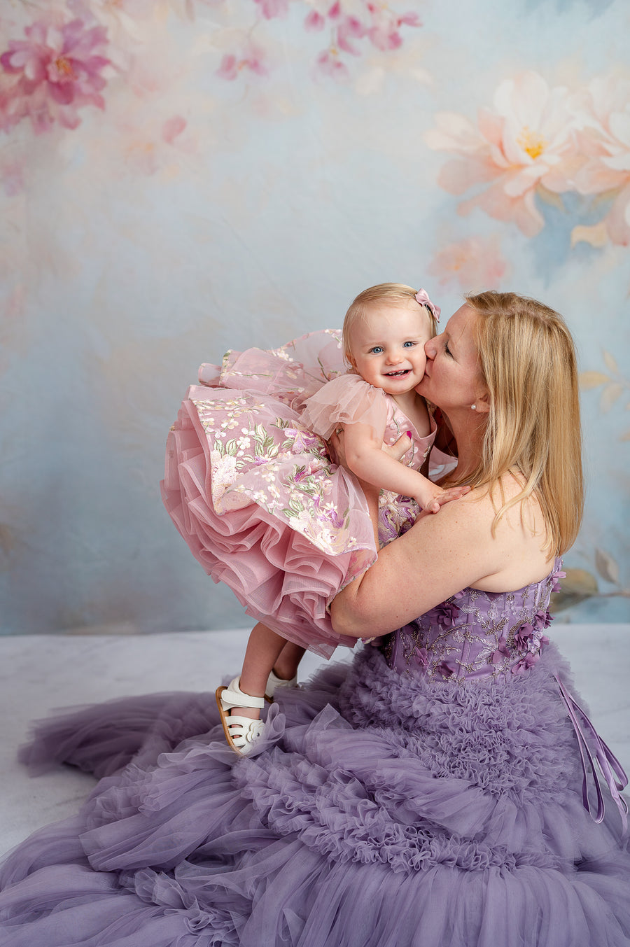 Elegant mommy and me styled shoot with lavender tulle gowns and garden-inspired setting.

