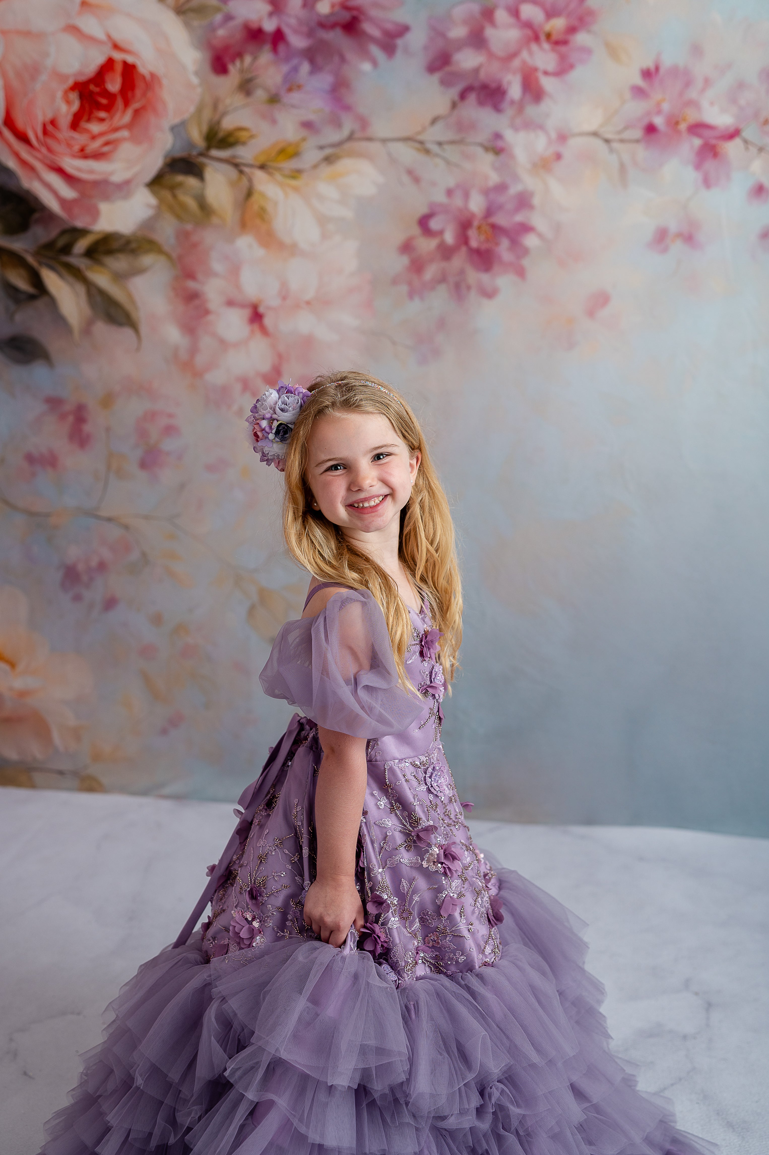 Whimsical child dress with dreamy lavender tones, floral accents, and puff sleeve option.

