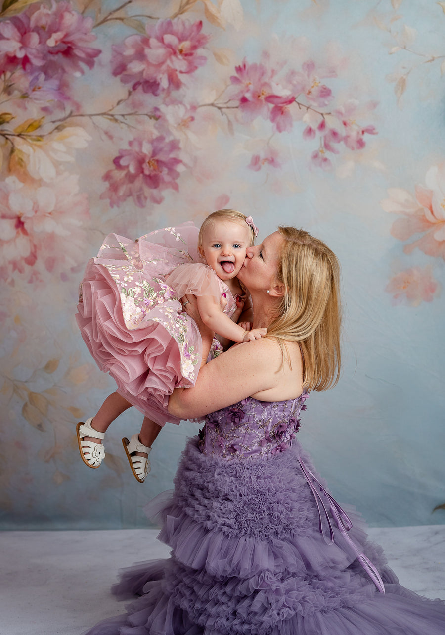Mommy and me image with matching gowns, floral crowns, and flowing lavender tulle.

