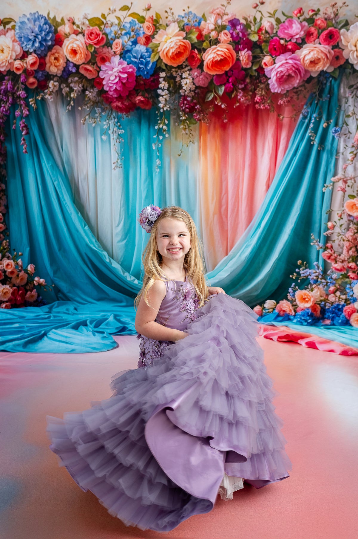 Styled children’s gown with lavender tulle, 3D floral appliqués, and removable puff sleeves.

